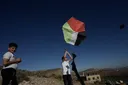 Palestinians fly kites over lands stolen by illegal Israeli settlers