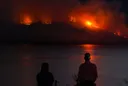 Fast-moving wildfires continue to tear across western US and Canada, forcing residents to flee