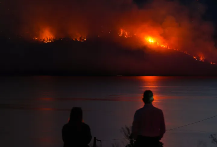 Fast-moving wildfires continue to tear across western US and Canada, forcing residents to flee