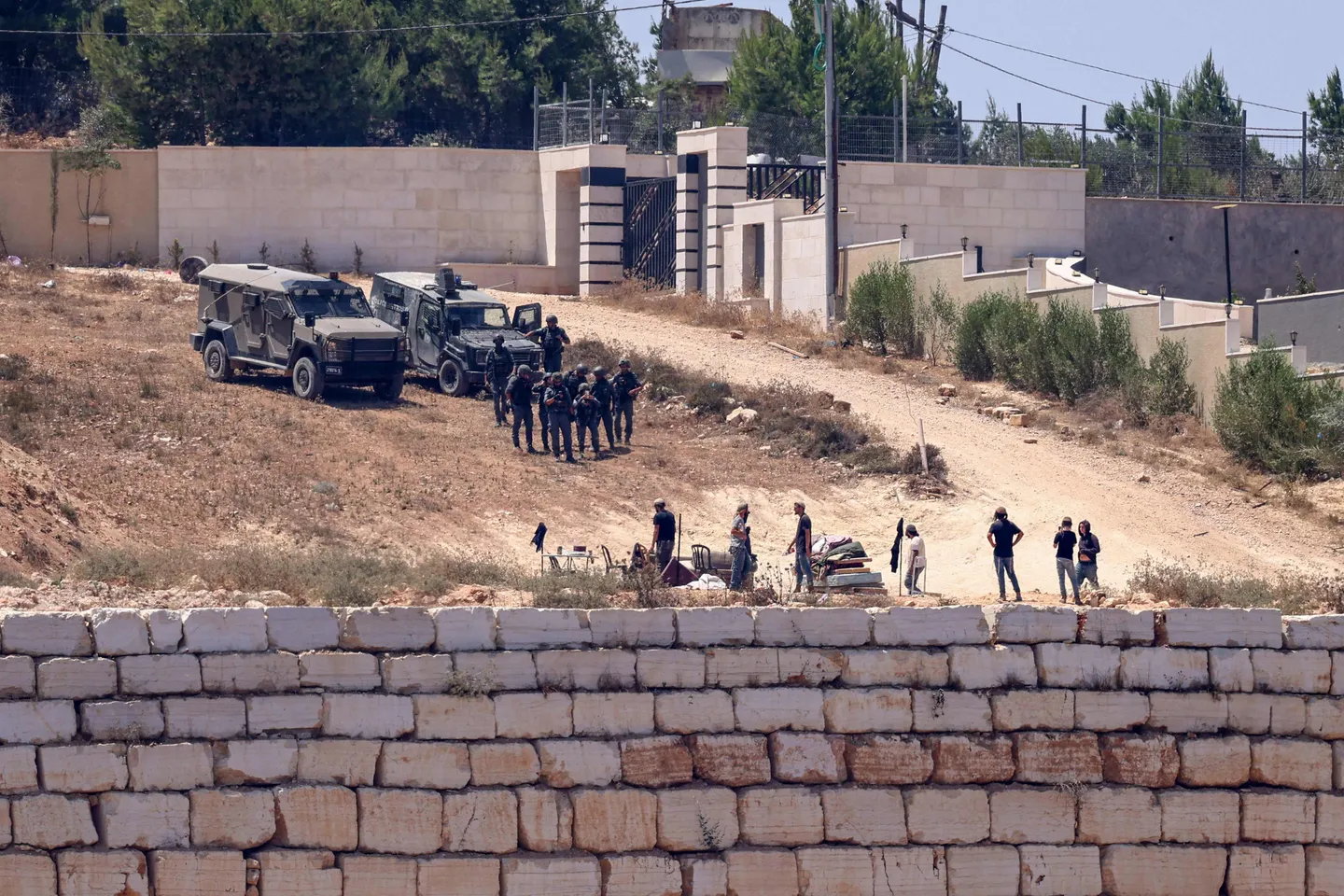 Israeli forces raid occupied West Bank town, declare curfew as illegal settlers besiege Palestinians