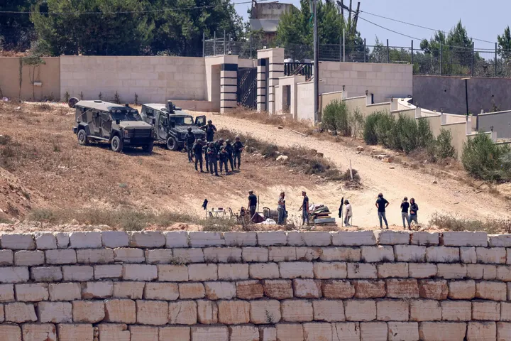 Israeli forces raid occupied West Bank town, declare curfew as illegal settlers besiege Palestinians