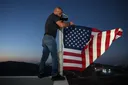 Palestinian-American raises US flag over home besieged by illegal Israeli settlers