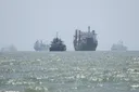 Iran agrees on temporary 7-mile Hormuz transit route with Oman, denies Strait is reopening