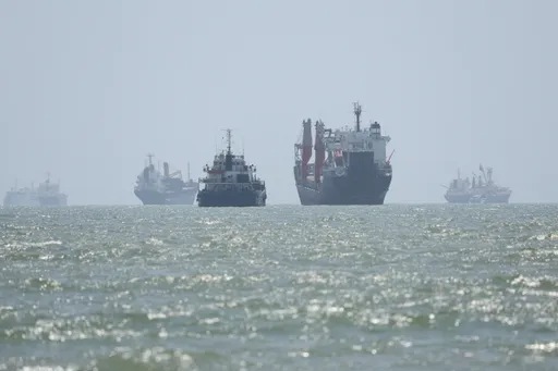 Iran agrees on temporary 7-mile Hormuz transit route with Oman, denies Strait is reopening